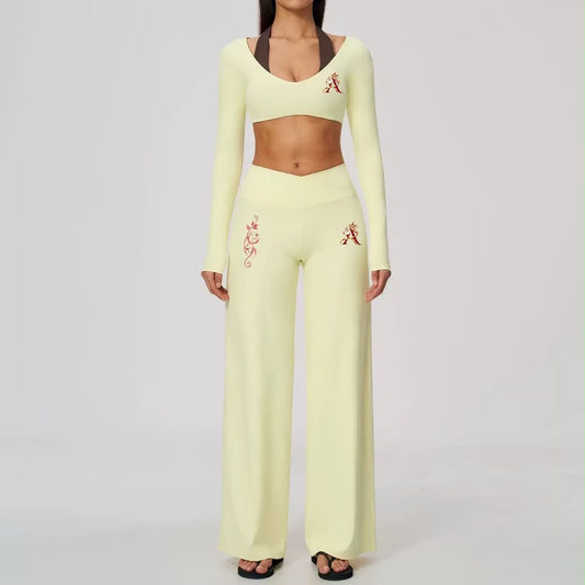Blush pink cropped long-sleeve top paired with matching high-waisted wide-leg pants
